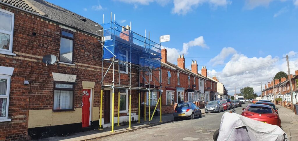 terraced house with scaffolding on the front - image 3