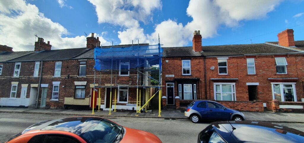 terraced house with scaffolding on the front - image 4