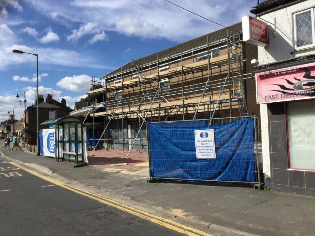 scaffolding on the front of a co-op store