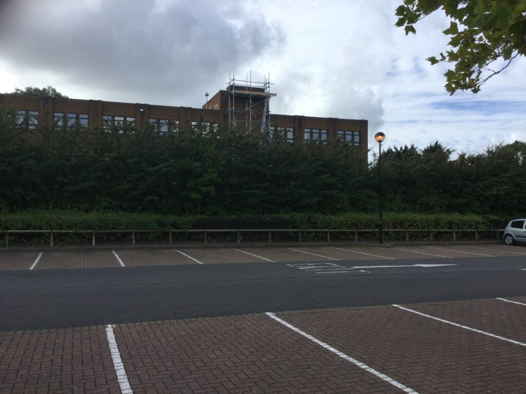 an image of scaffolding equipment on the back of the government office in Lincoln taken from a car park