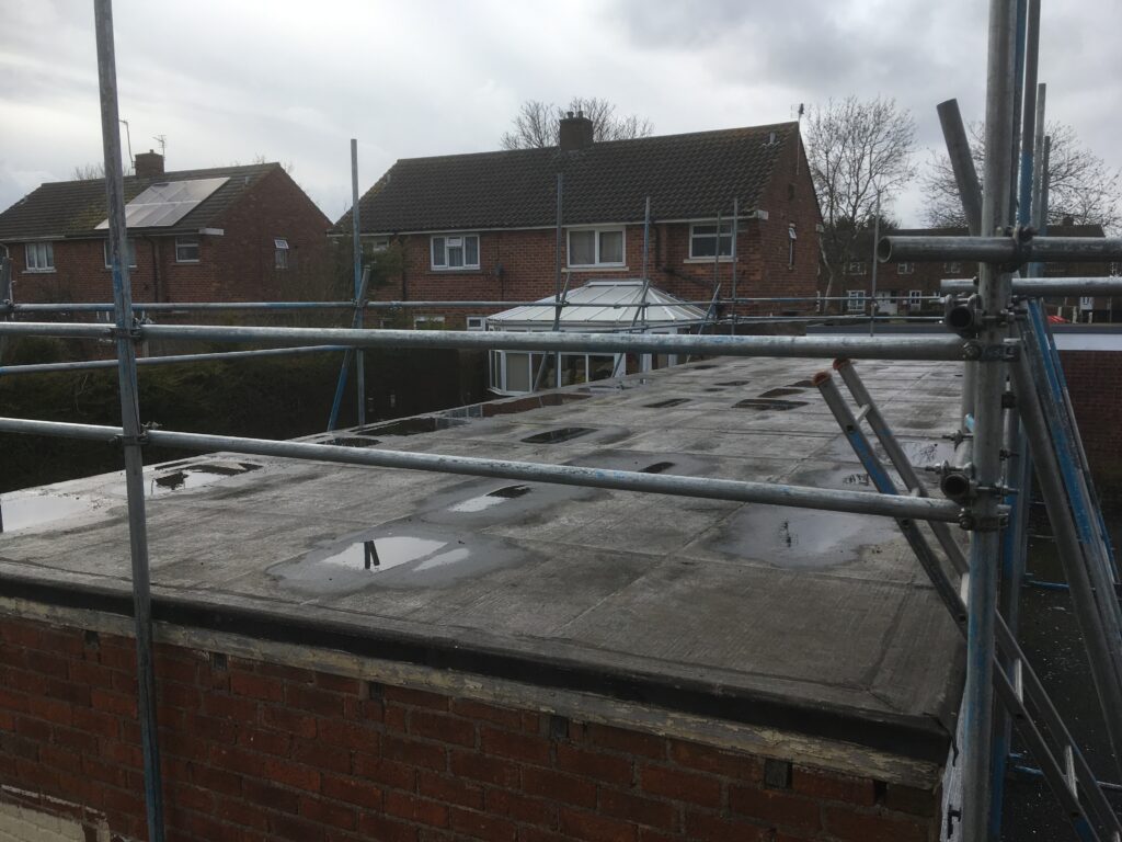 scaffolding on surrounding a block of garages for roof work