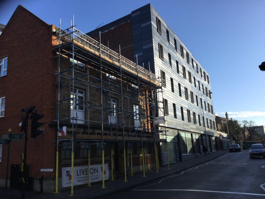 commercial scaffolding on a building by a road in Lincoln