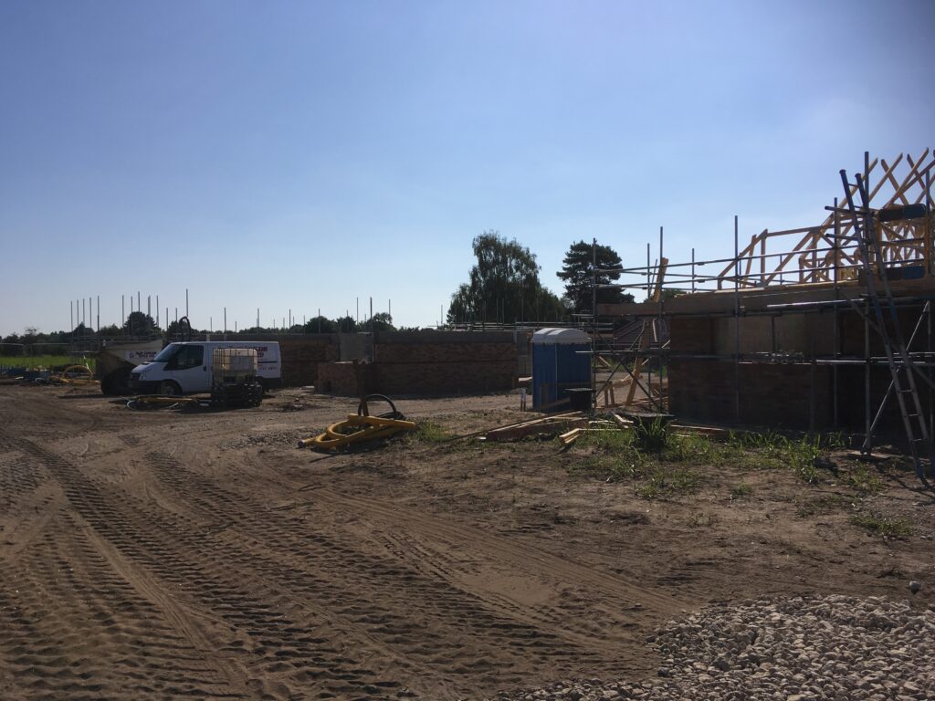 scaffolding surround bungalows under construction - roofing - image 5