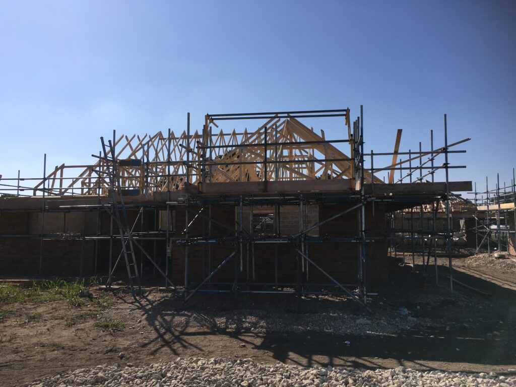 scaffolding surround bungalows under construction - roofing - image 4