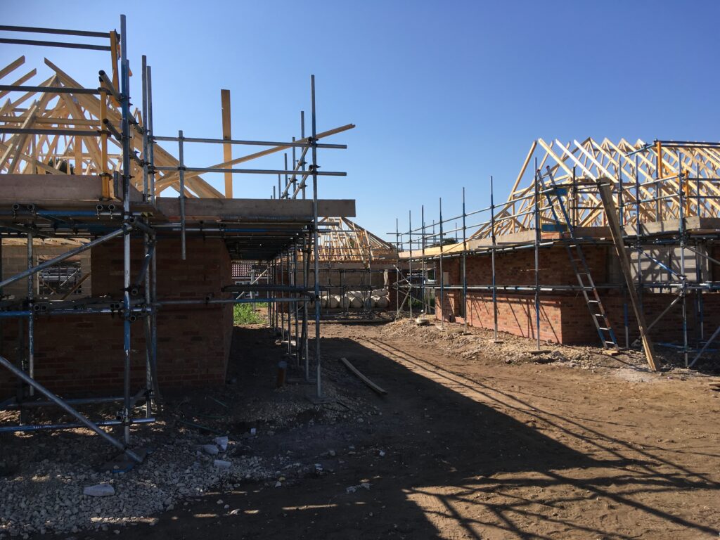 scaffolding surround bungalows under construction - roofing - image 2