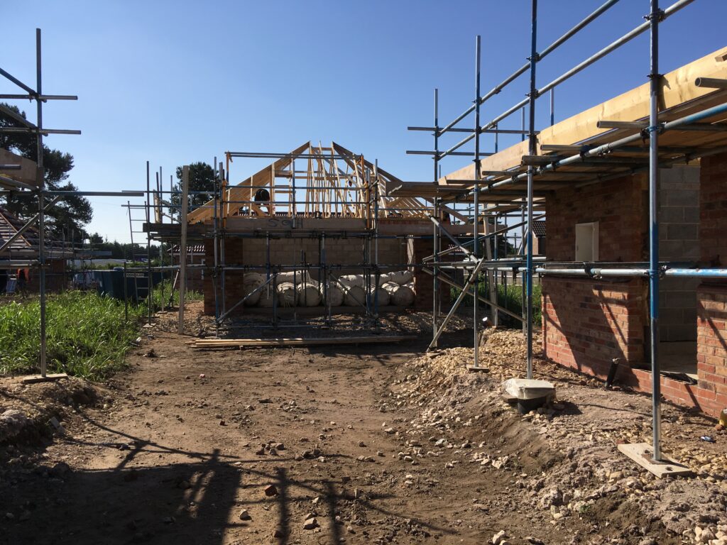 scaffolding surround bungalows under construction - roofing