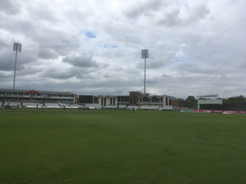 large cricket pitch with seating stands - image 2