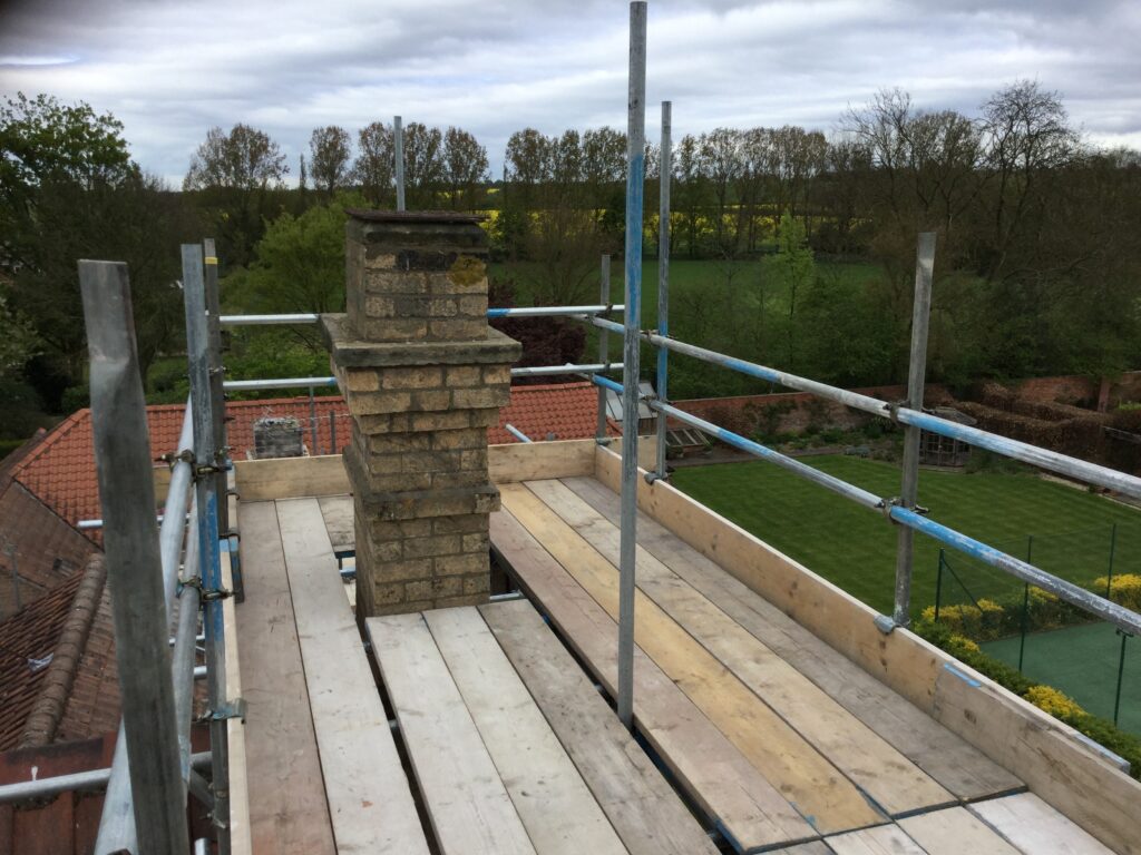 scaffolding surrounding a chimney - image 2