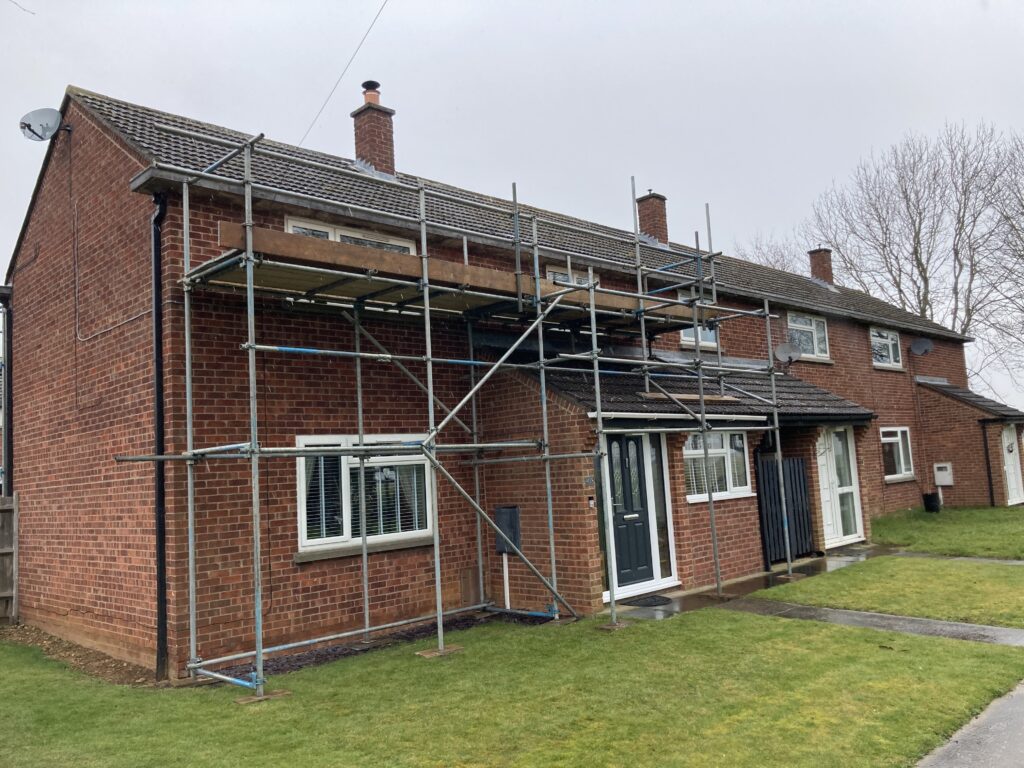 scaffolding on the front of a small terraced house - image 2