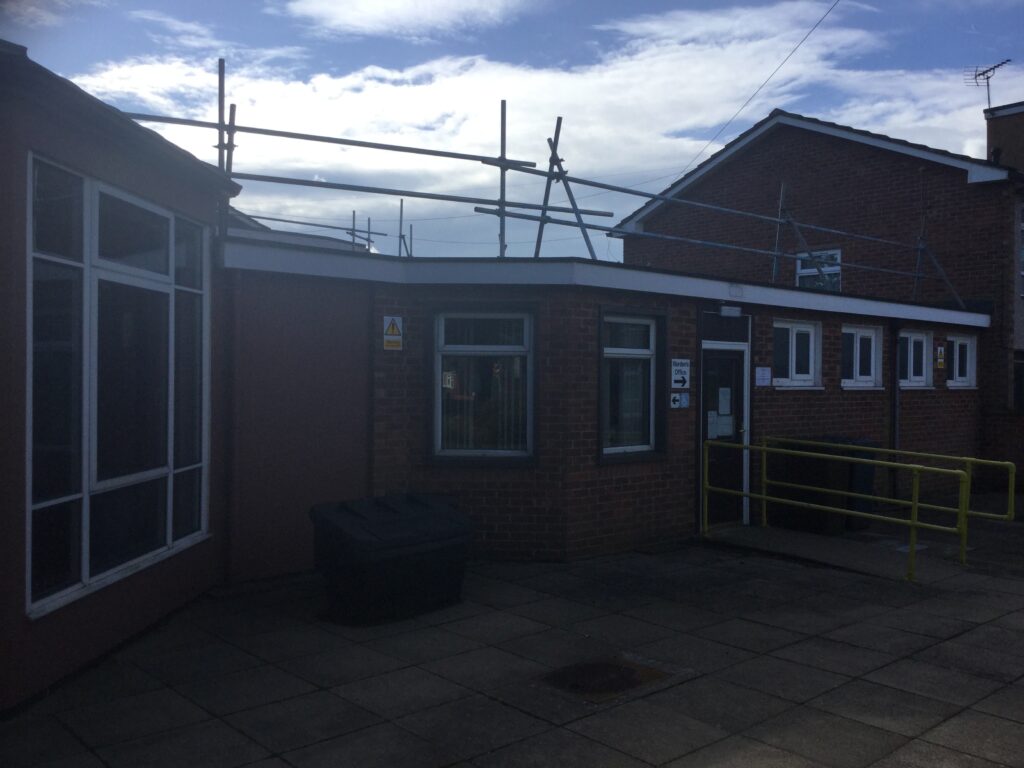 scaffolding on the first roof of a building - image 2