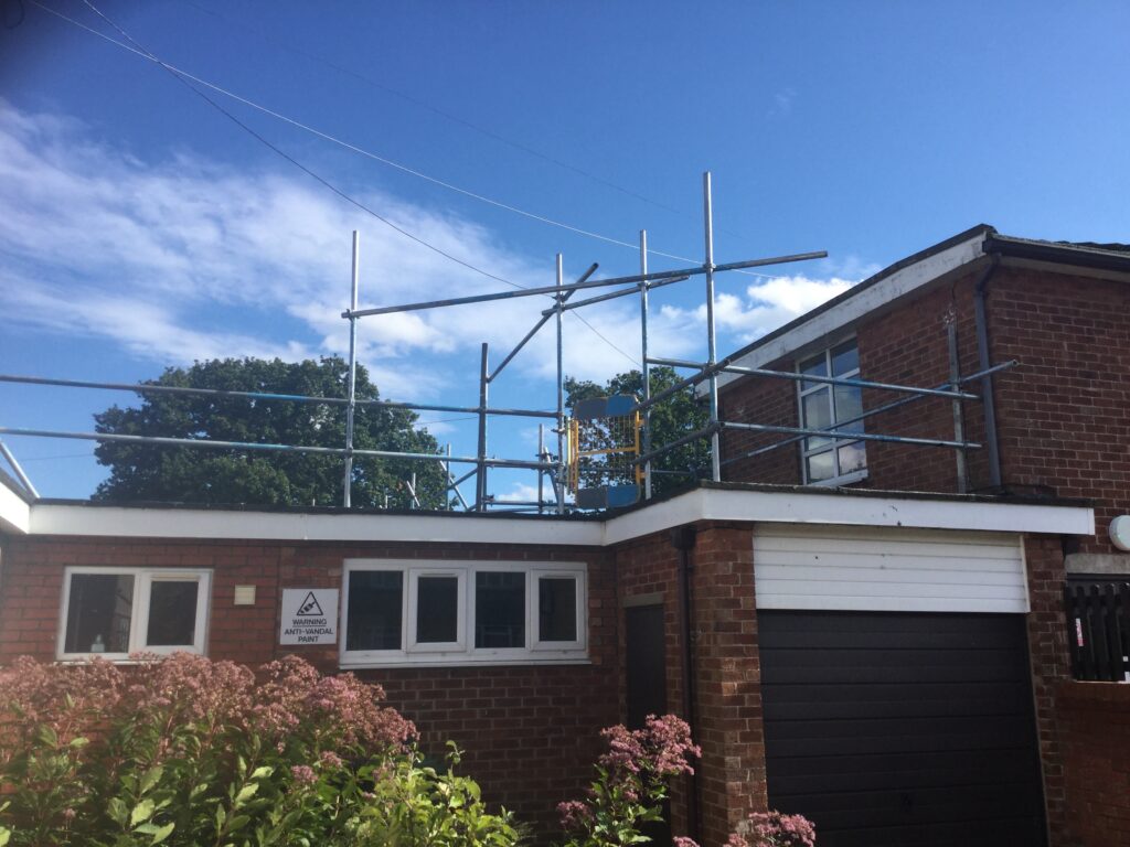 scaffolding on the roof of a garage