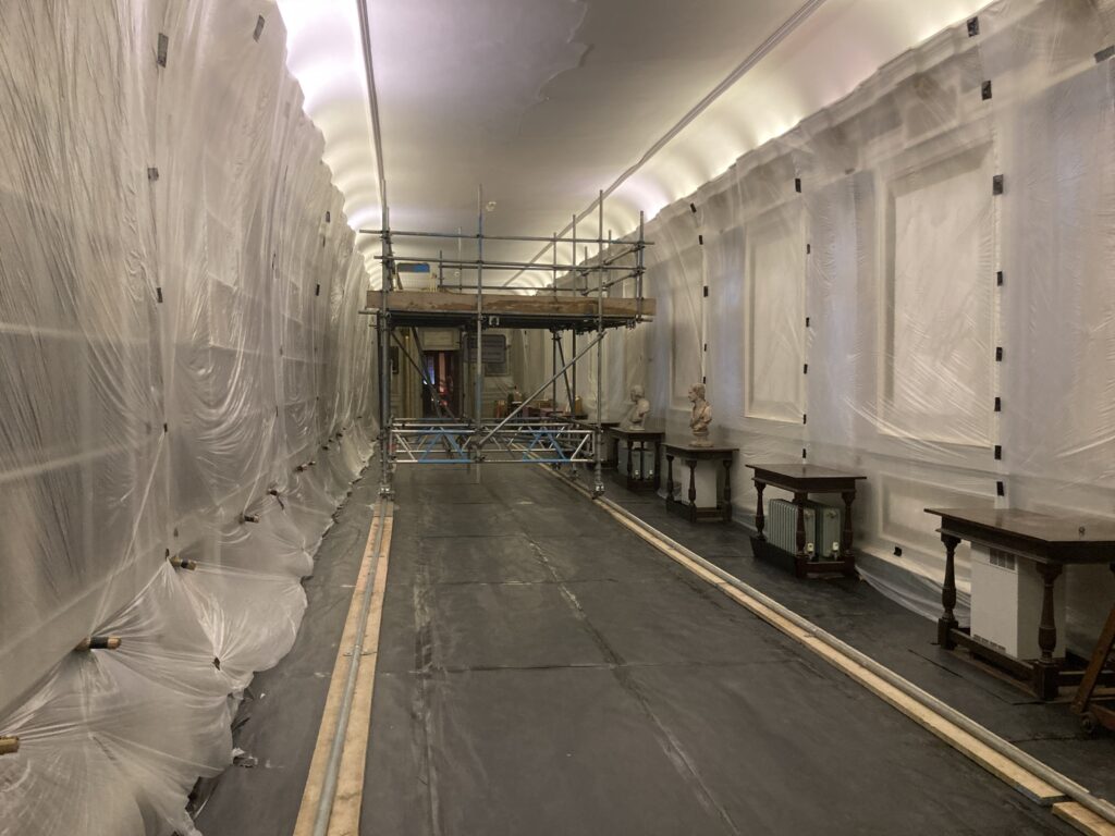 scaffolding in the center of a long hallway - image 1