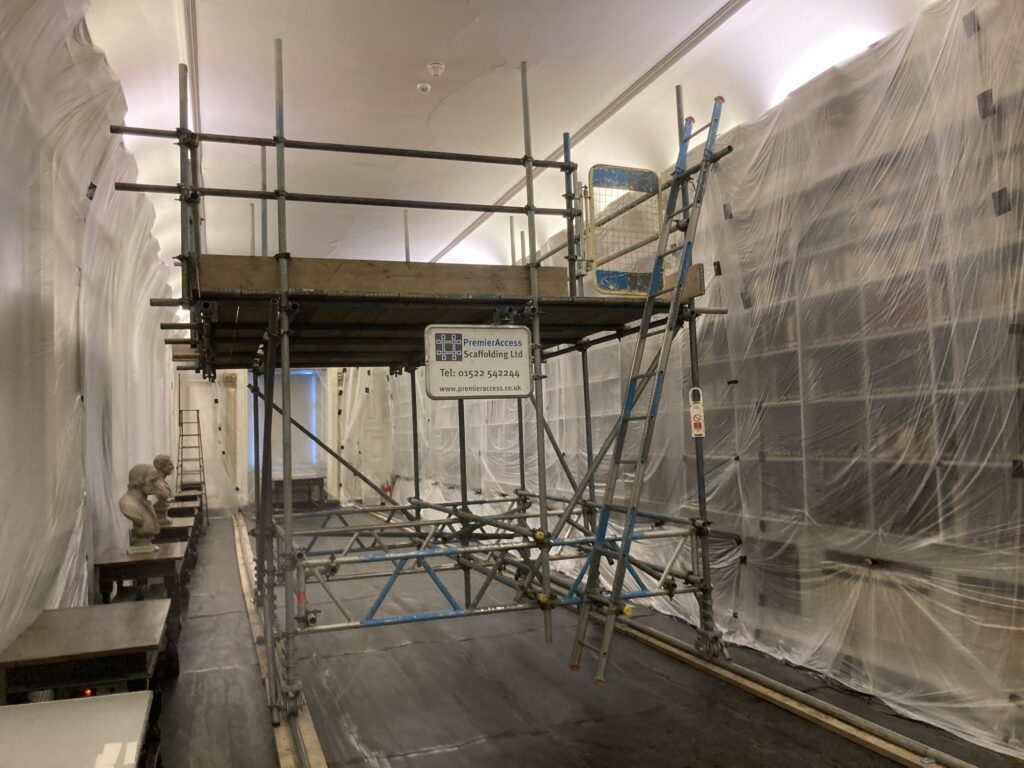 scaffolding in the center of a long hallway - image 2
