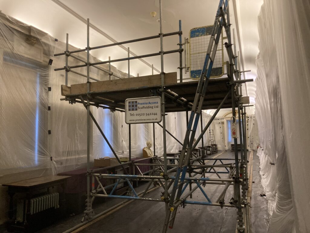 scaffolding in the center of a long hallway - image 3