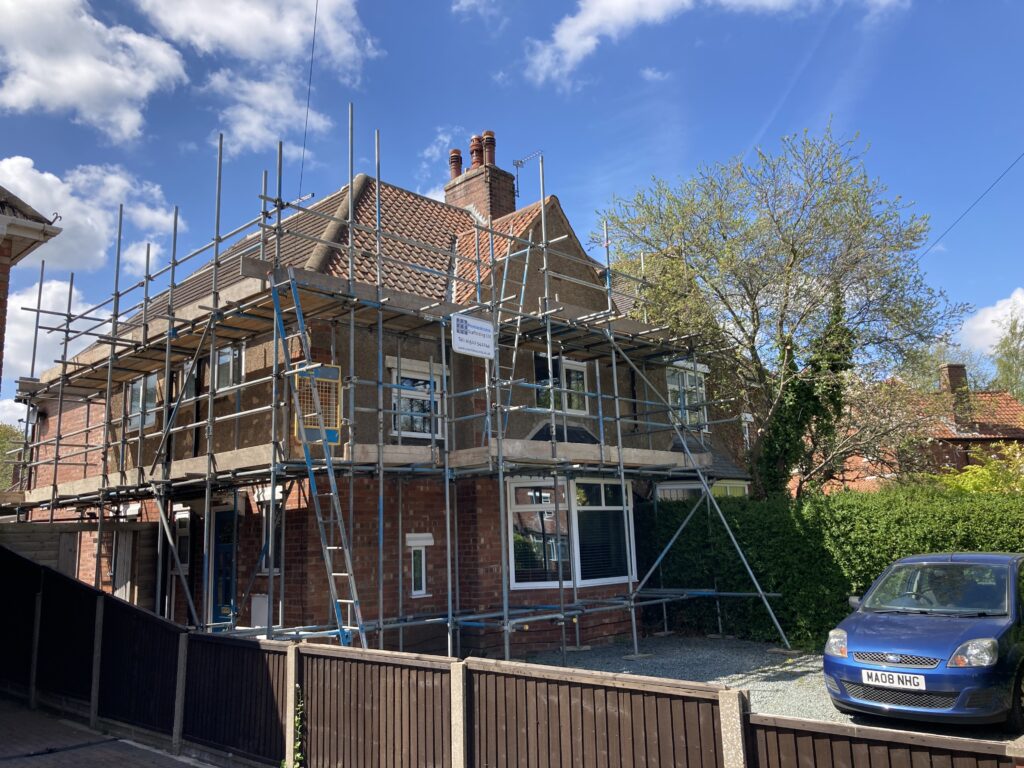 two story house surrounded by scaffolding - image 2
