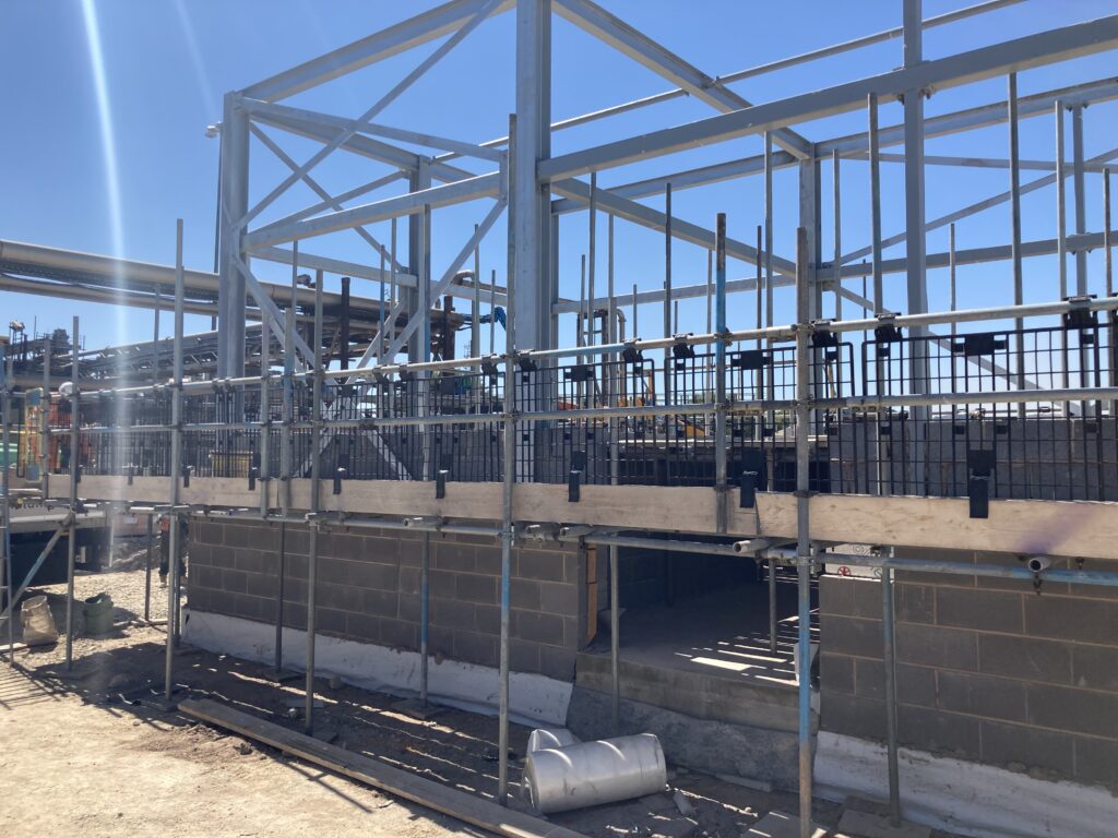 scaffolding being erected around a room being constructed at a sugar factory in Newark