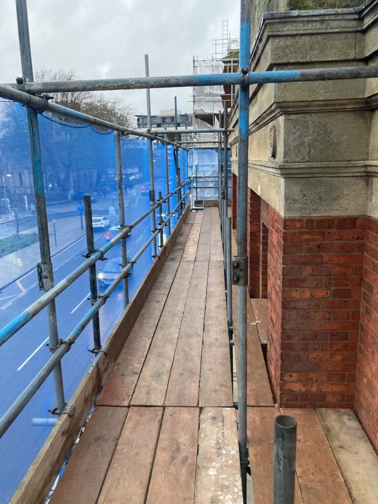 scaffolding on a building by a busy road in Lincoln