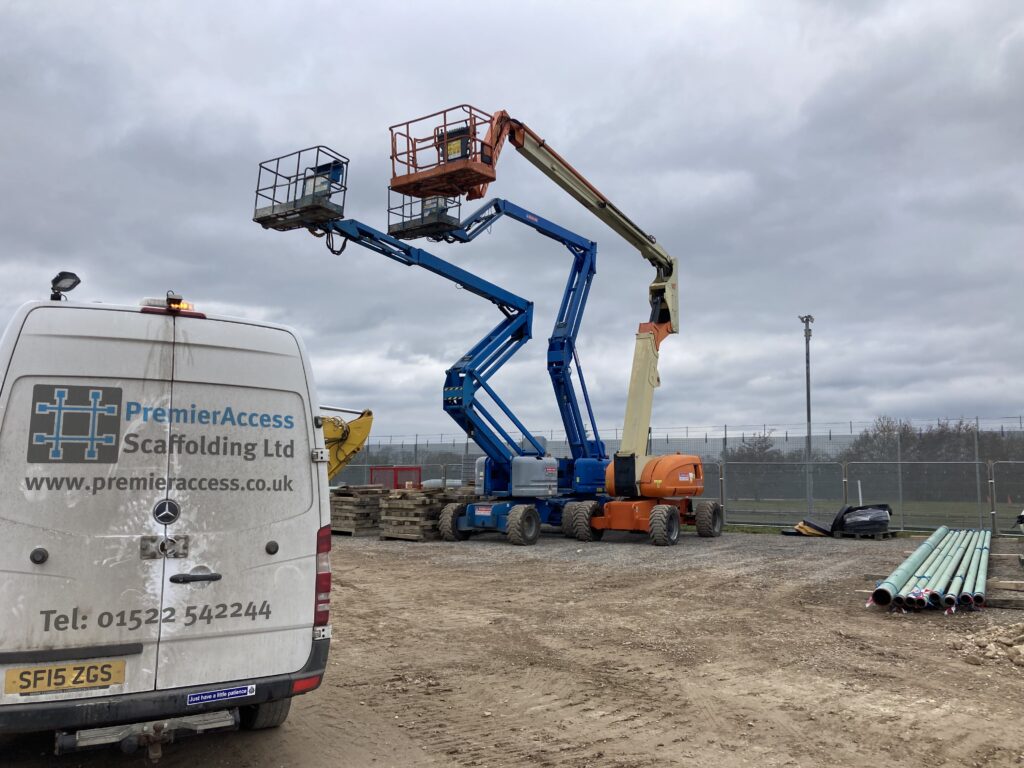 two powered access machines on a construction site