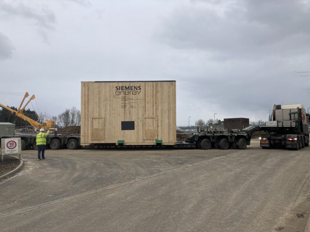 lorry moving a covered gas compressor