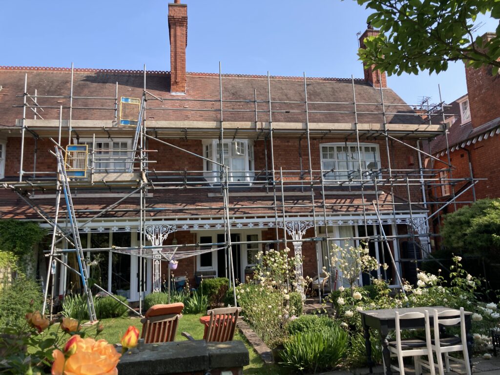 scaffolding on the front of a house to help install solar panels