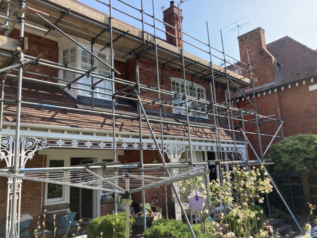 scaffolding on the front of a house to help install solar panels